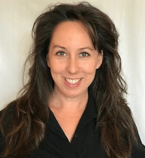 Portrait of smiling woman in black top