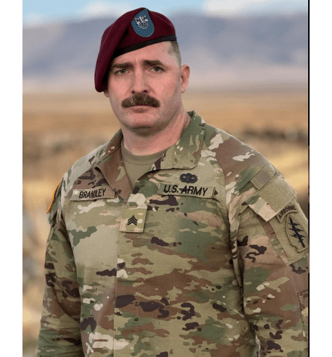 U.S. Army soldier in camouflage uniform outdoors.