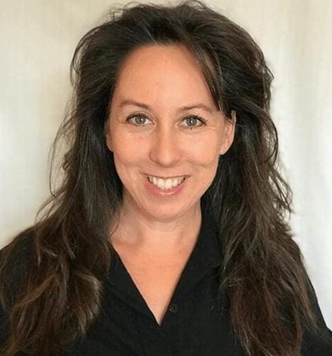 Smiling woman with long, dark hair.